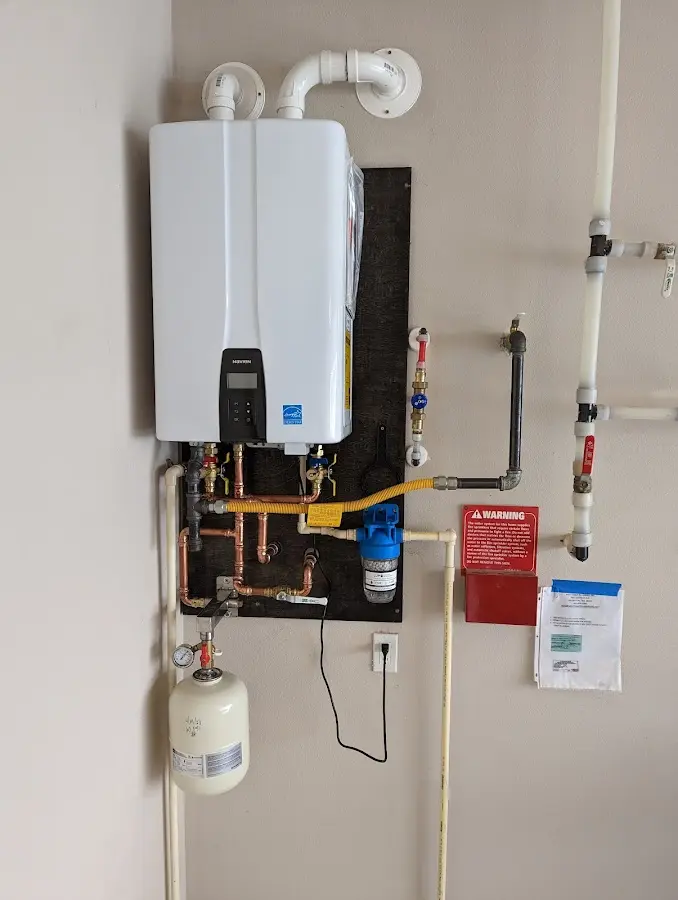 Professional plumber installing copper piping in a Layhill home